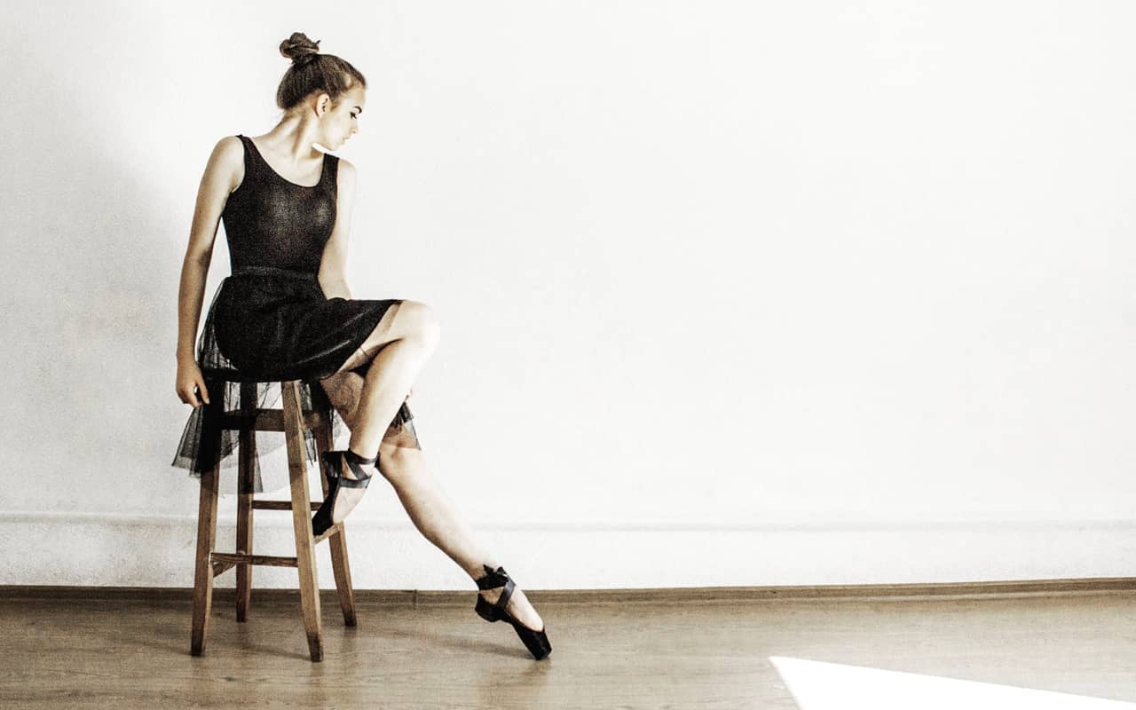 a dancer is sitting on a chair