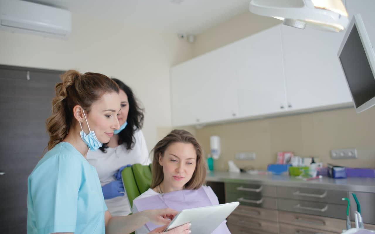 a dentist talks to her patient