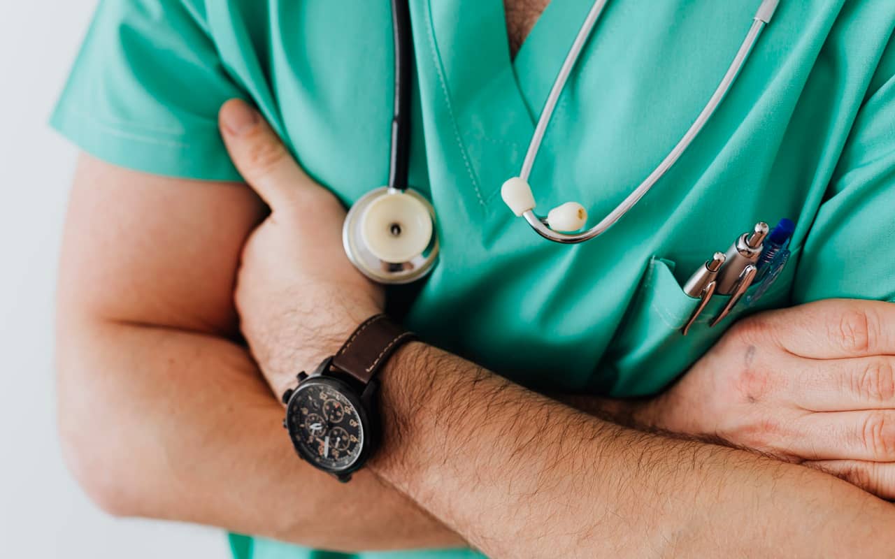 a doctor wears green cloth and black watch