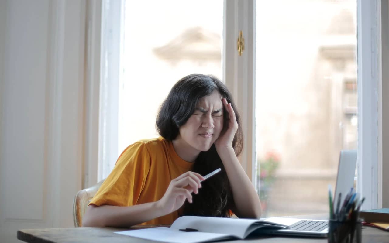 a girl is struggling with learning