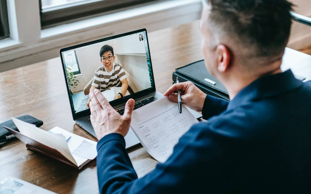 a man is learning online with a teacher