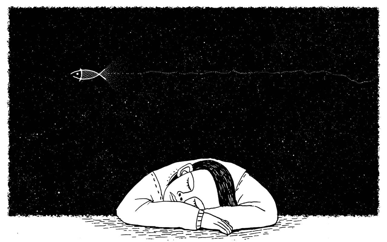 a man is sleeping on a desk and dreaming