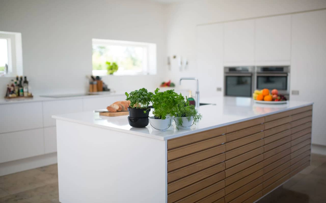 a nice kitchen with fruits and bread on the counter