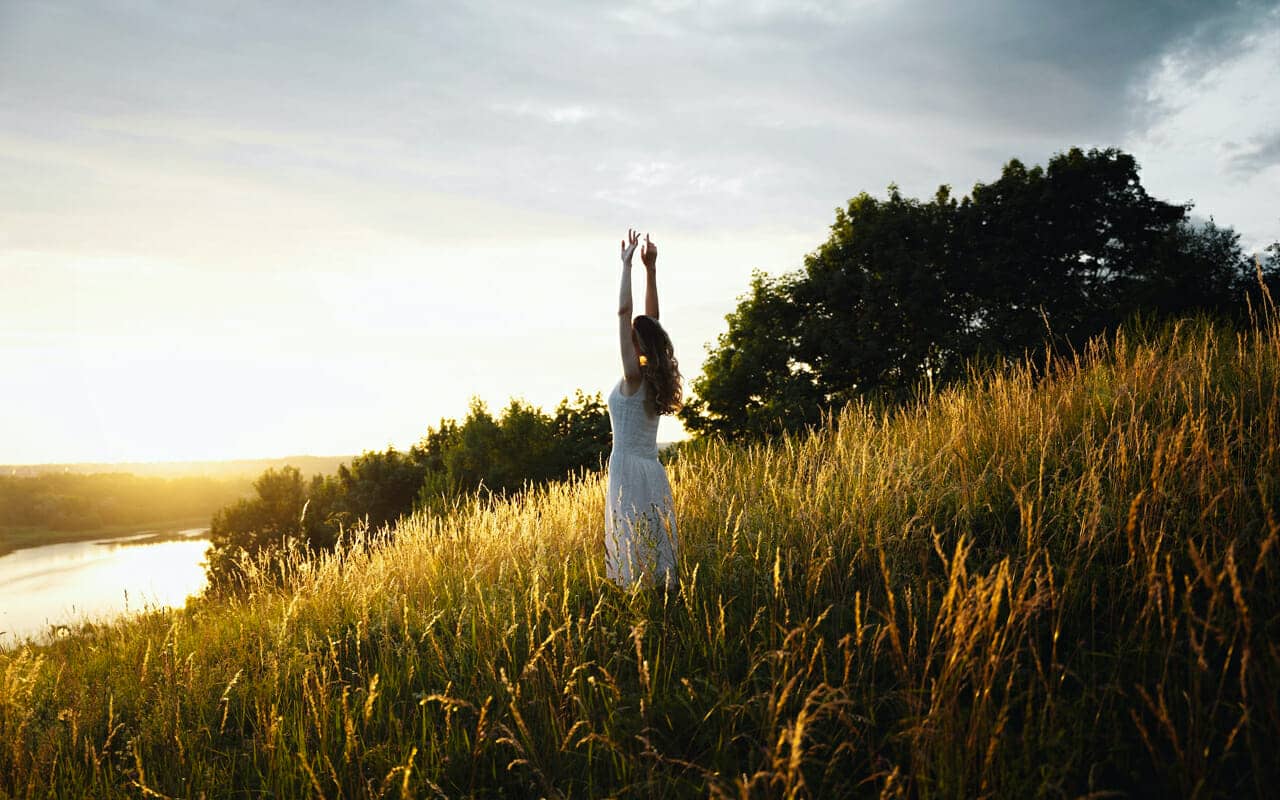 a relaxed woman wears a white dress