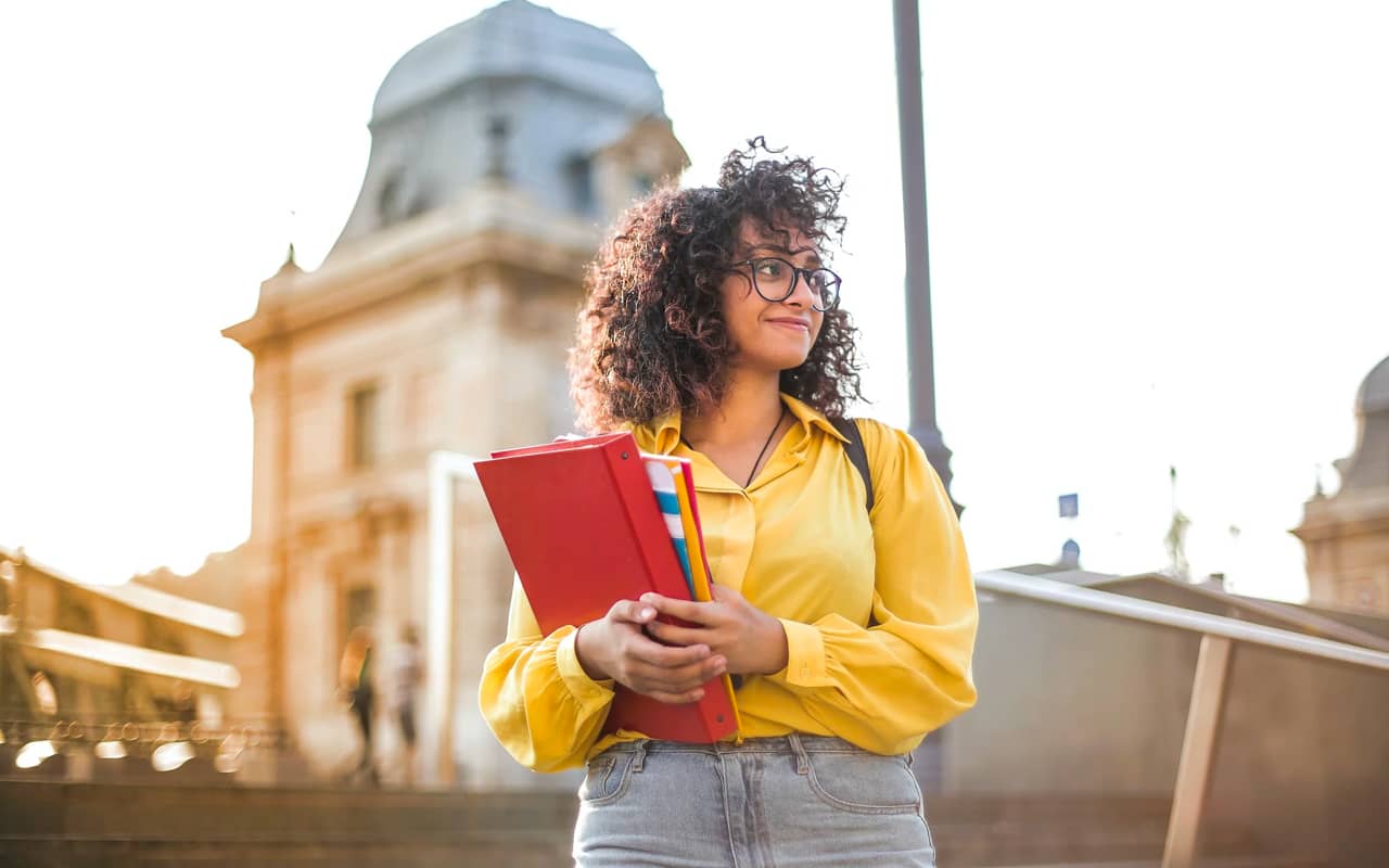 a student walking with some books