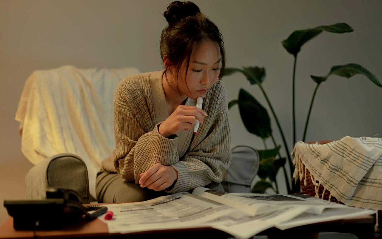 a woman is reading and thinking