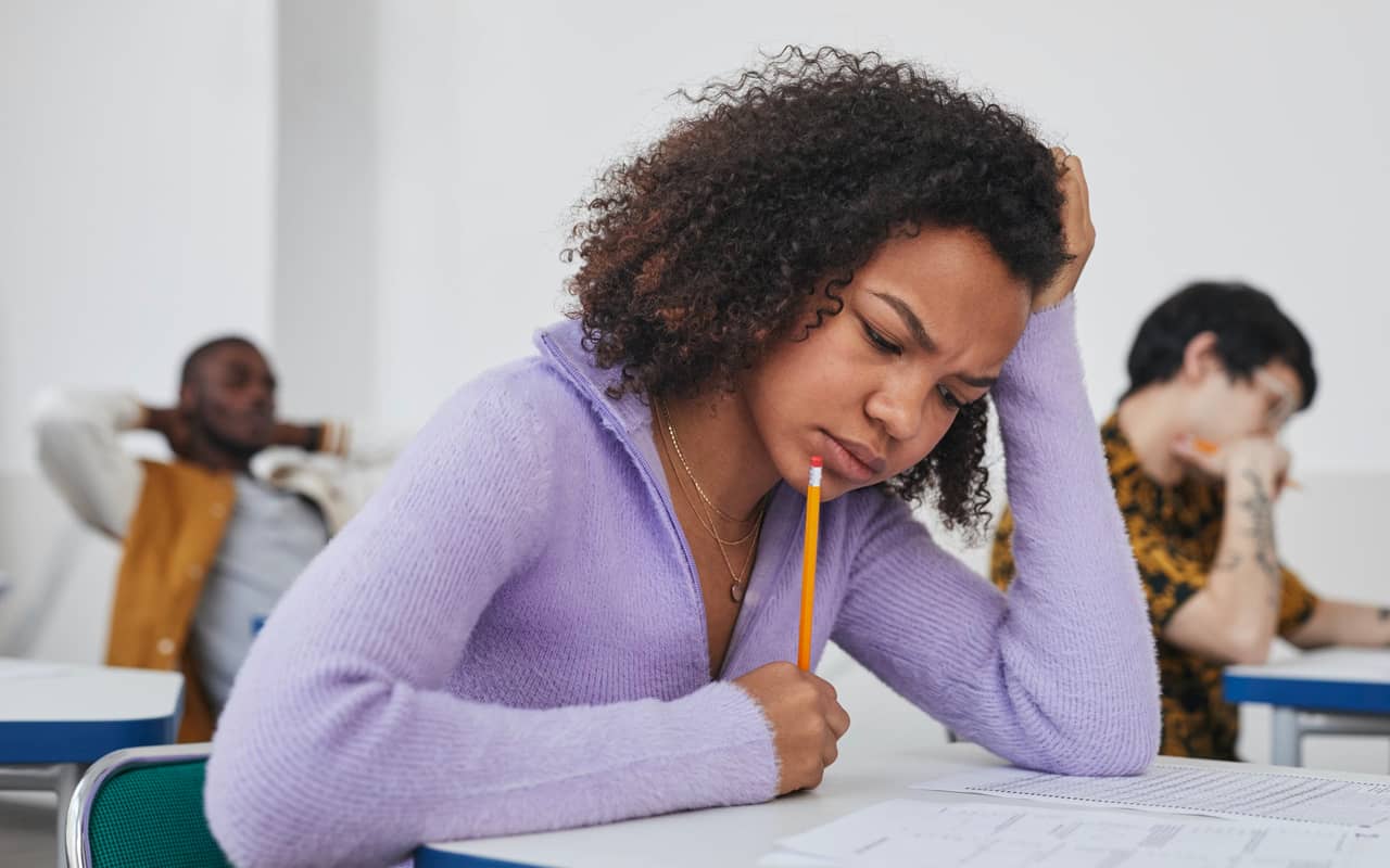 a woman is struggling in an exam