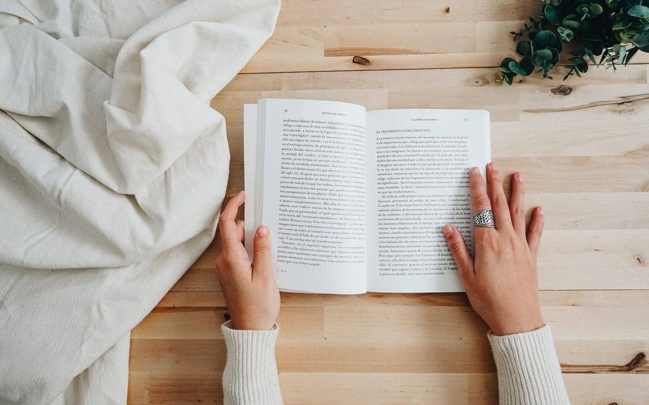 an opened book on wooden desk