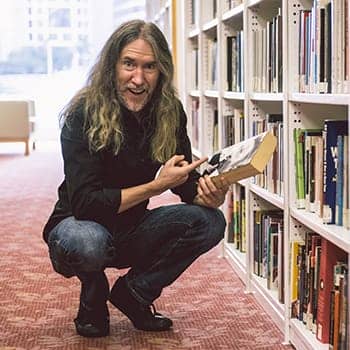 Anthony Metivier pointing to a book to illustrate a concept about how to learn faster