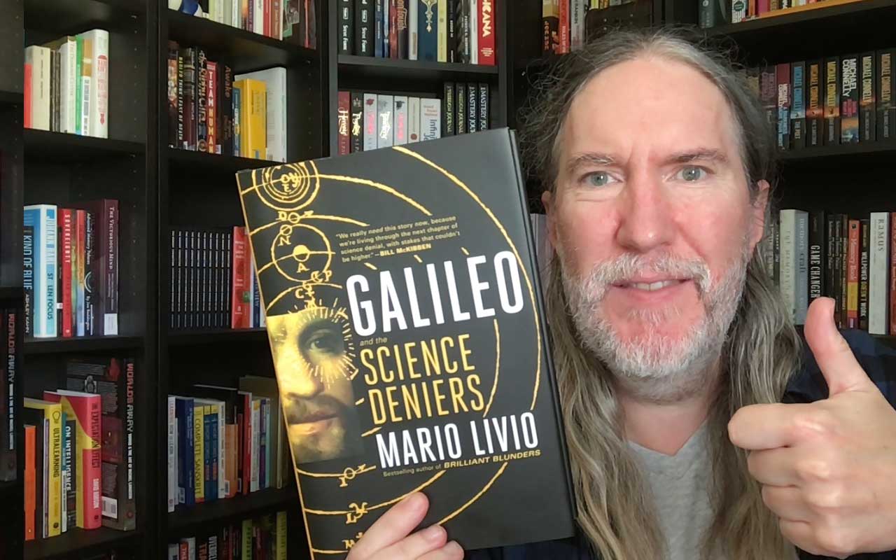 Anthony Metivier with a copy of Galileo and the Science Deniers by Mario Livio