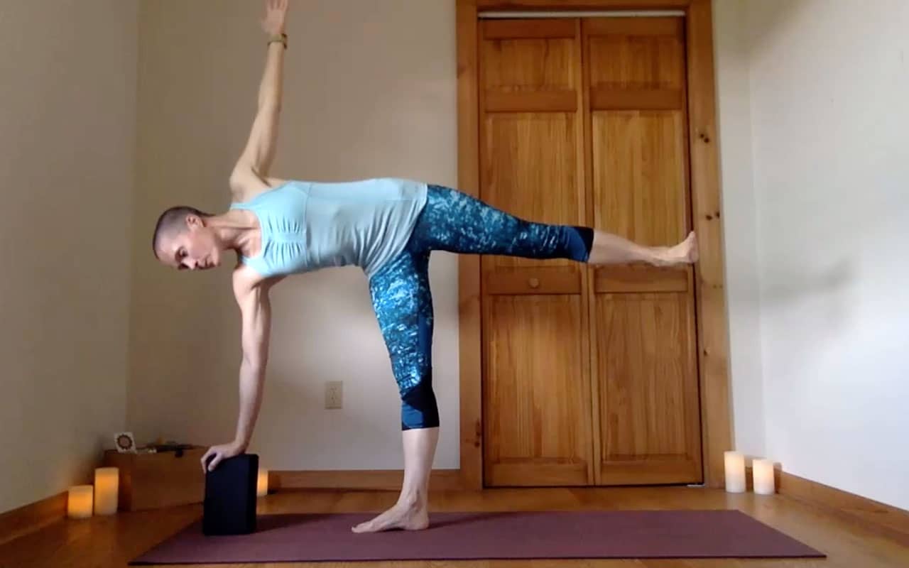 The pose author demonstrates Ardha Chandrasana (Half Moon).