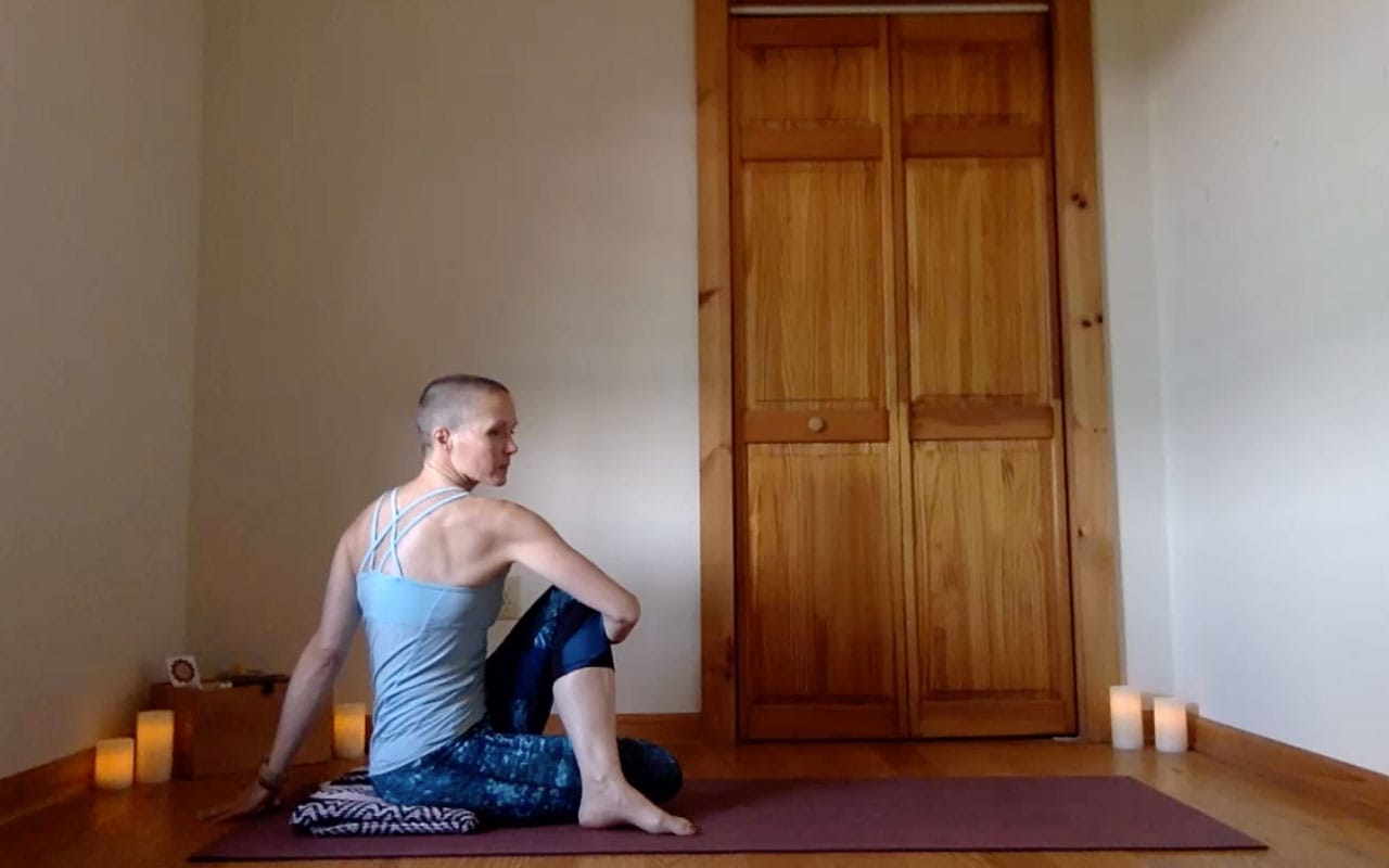 The post author demonstrates Ardha Matsyendrasana (Half Spinal Twist).