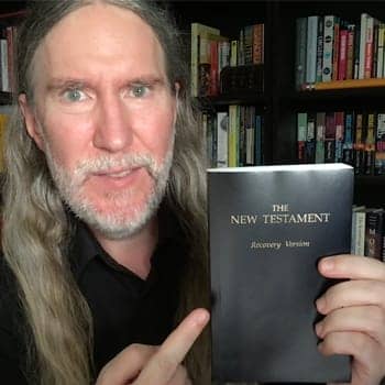 Bible verses to memorize feature image with Anthony Metivier holding a copy of the New Testament