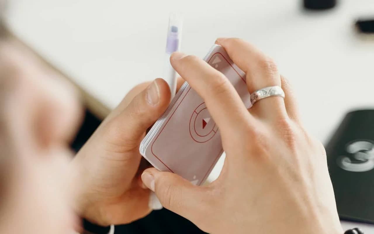 cards and a pen holded by hands