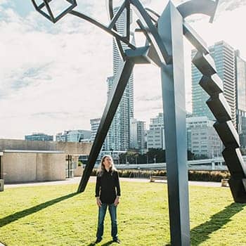 Anthony Metivier looking at a dynamic statue in Brisbane to express a concept related to cognitive training