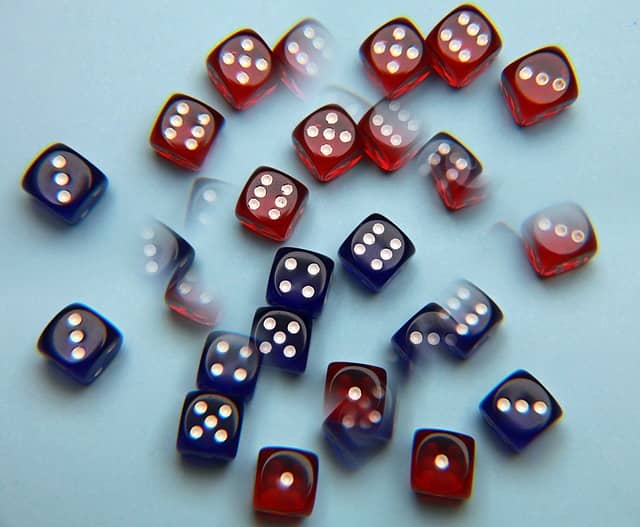 Image of blurred dice to express a concept related to the Cosmic Journal