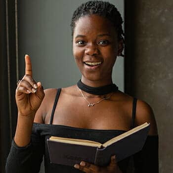 how to improve reading comprehension feature image of a happy woman reading a book