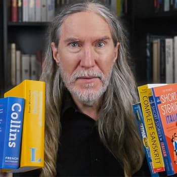 Anthony Metivier holding language learning guide books for how to learn a new language feature image