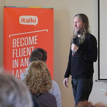 How to memorize a sales script feature image of Anthony Metivier presenting an offer from the stage