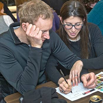 how to remember trivia feature image with people filling out a trivia quiz