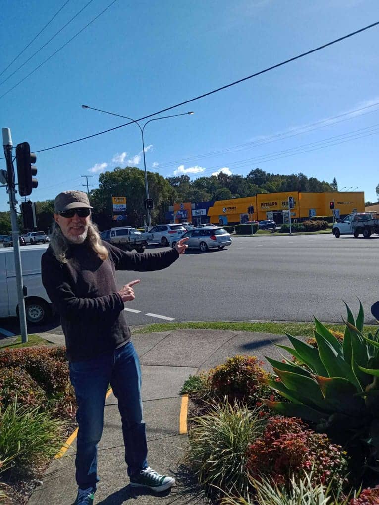 Anthony Metivier standing in front of Pet Barn to demonstrate how to memorize vocabulary using a Memory Palace and mnemonic images