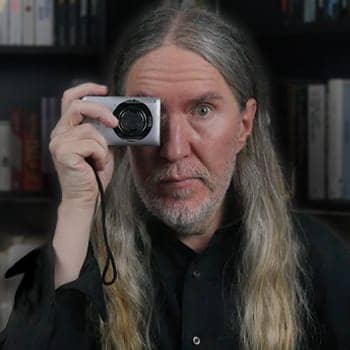 Anthony Metivier holding a camera to illustrate the problems with photographic memory