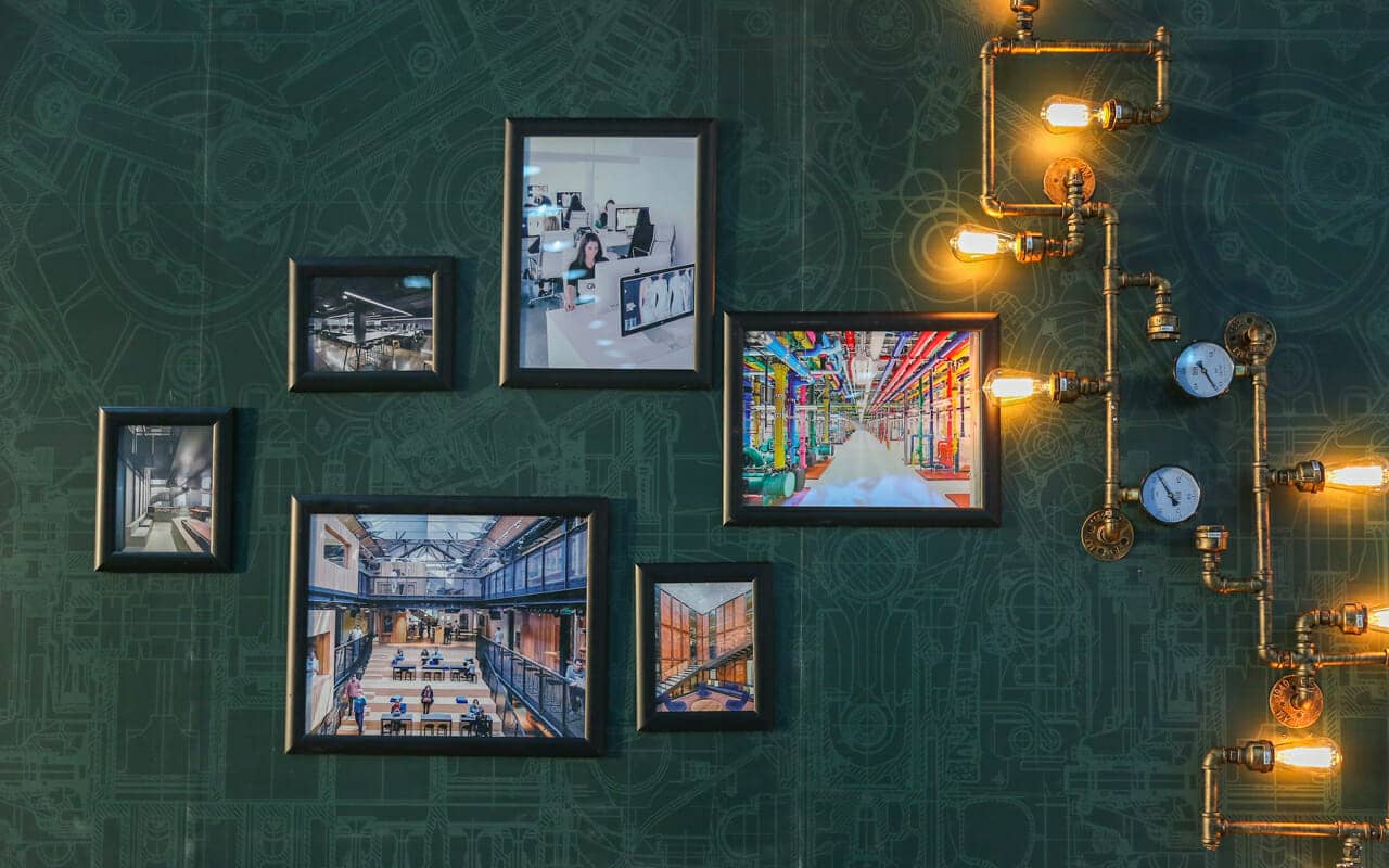 pictures on a green wall with lights