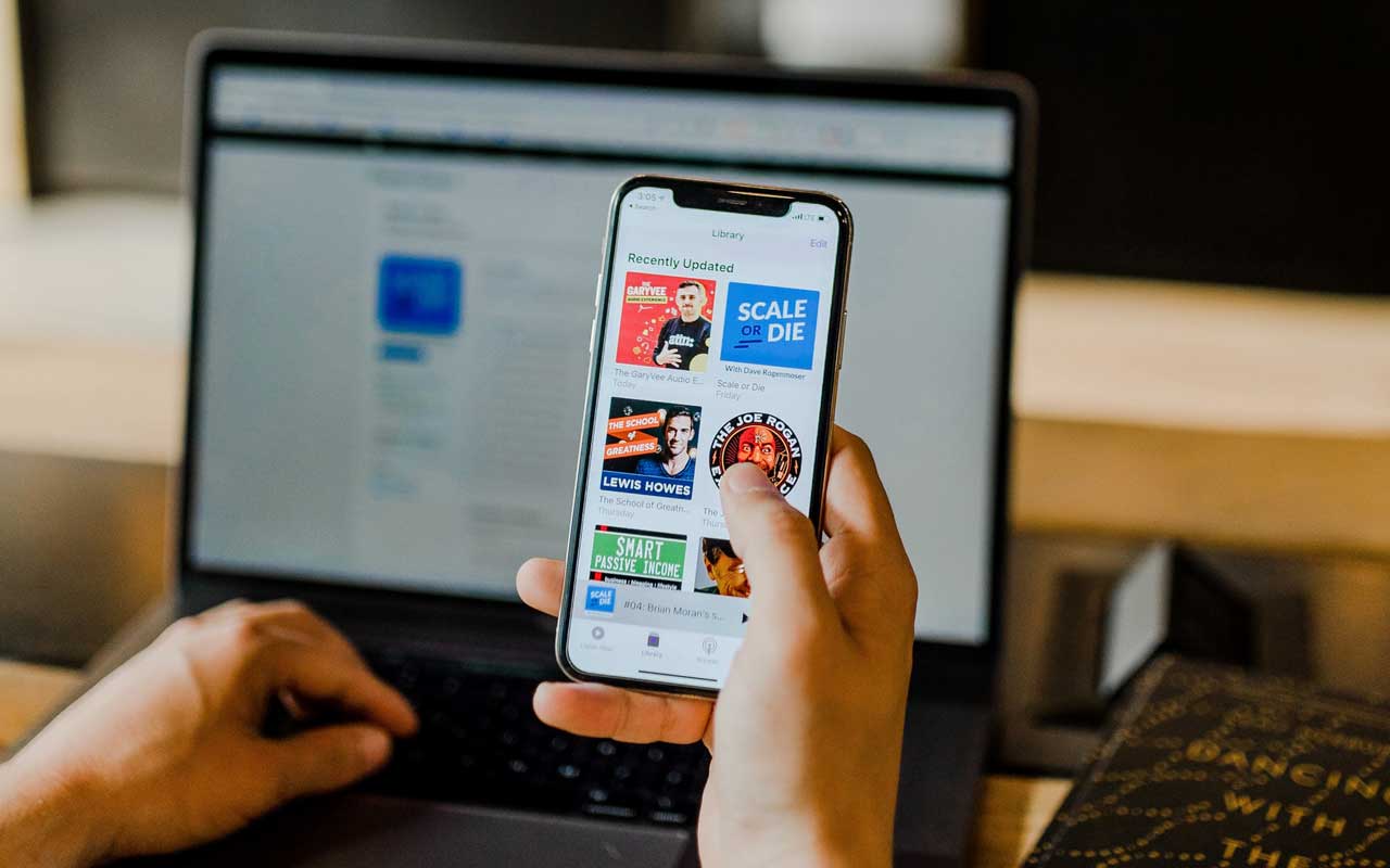 A smartphone with a list of podcasts on the screen.