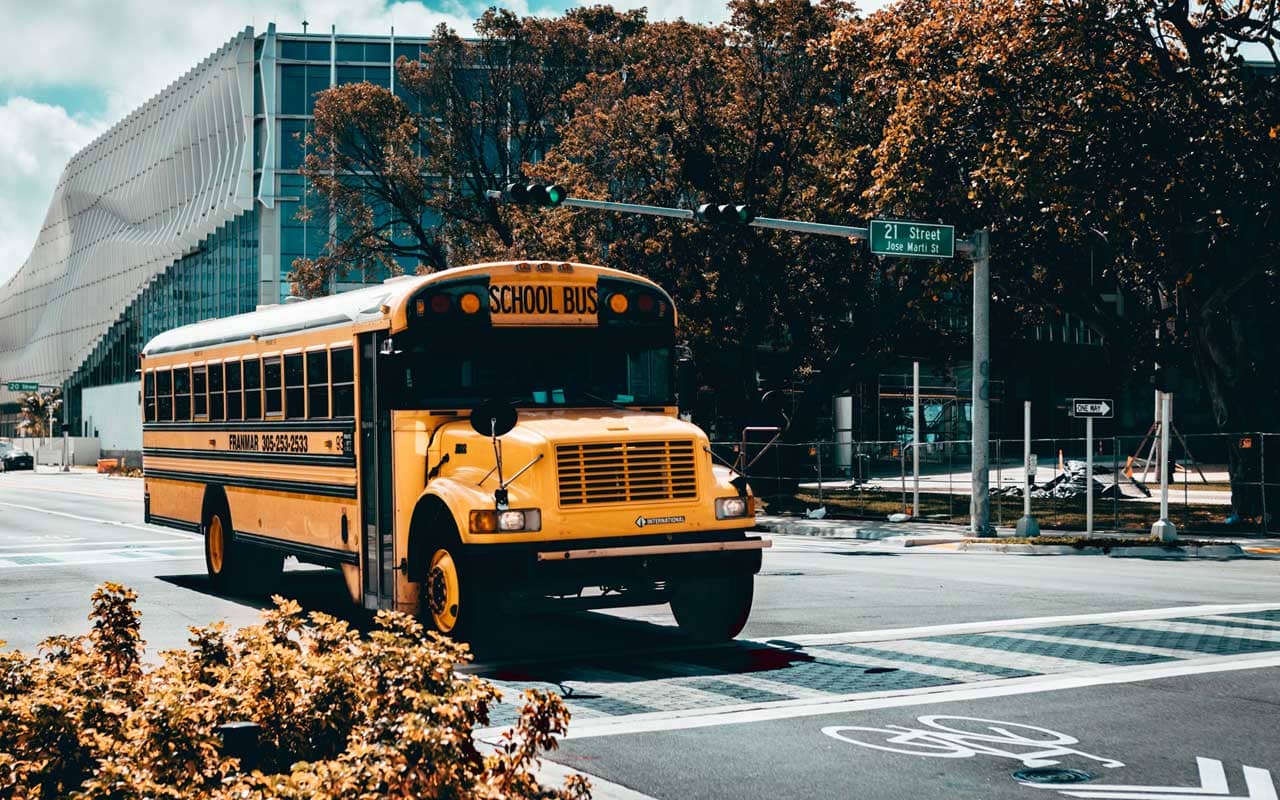A school bus crosses an intersection. An example of priming is to associate the word "school" with the image of a school bus.