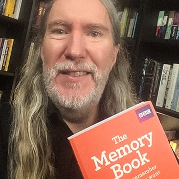 Anthony Metivier holding his copy of The Memory Book by Tony Buzan