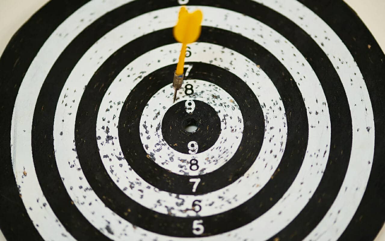 yellow dart on a black and white dartboard